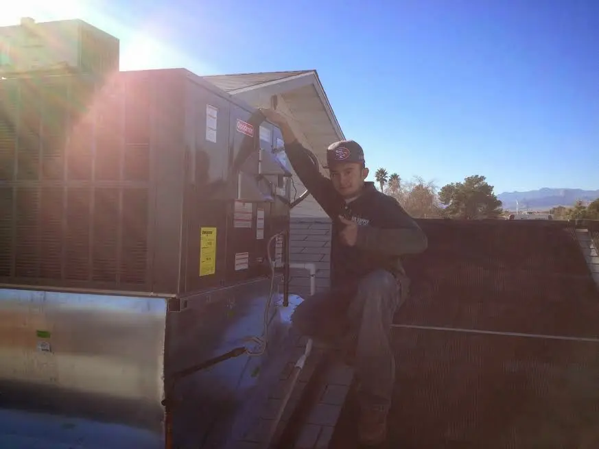 HVAC technician performing AC Tune-Up on a rooftop unit in York
